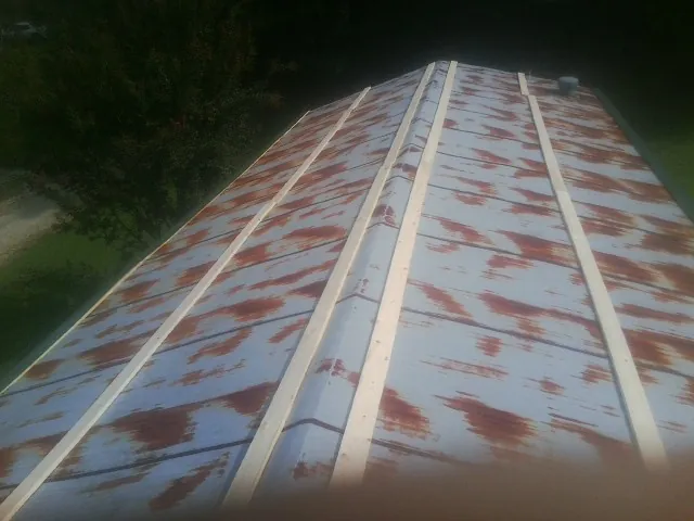 Rusted metal roof panels with new wood purlins before replacement — Storm Damage Roof Repair in Dumfries by Roofing Brothers