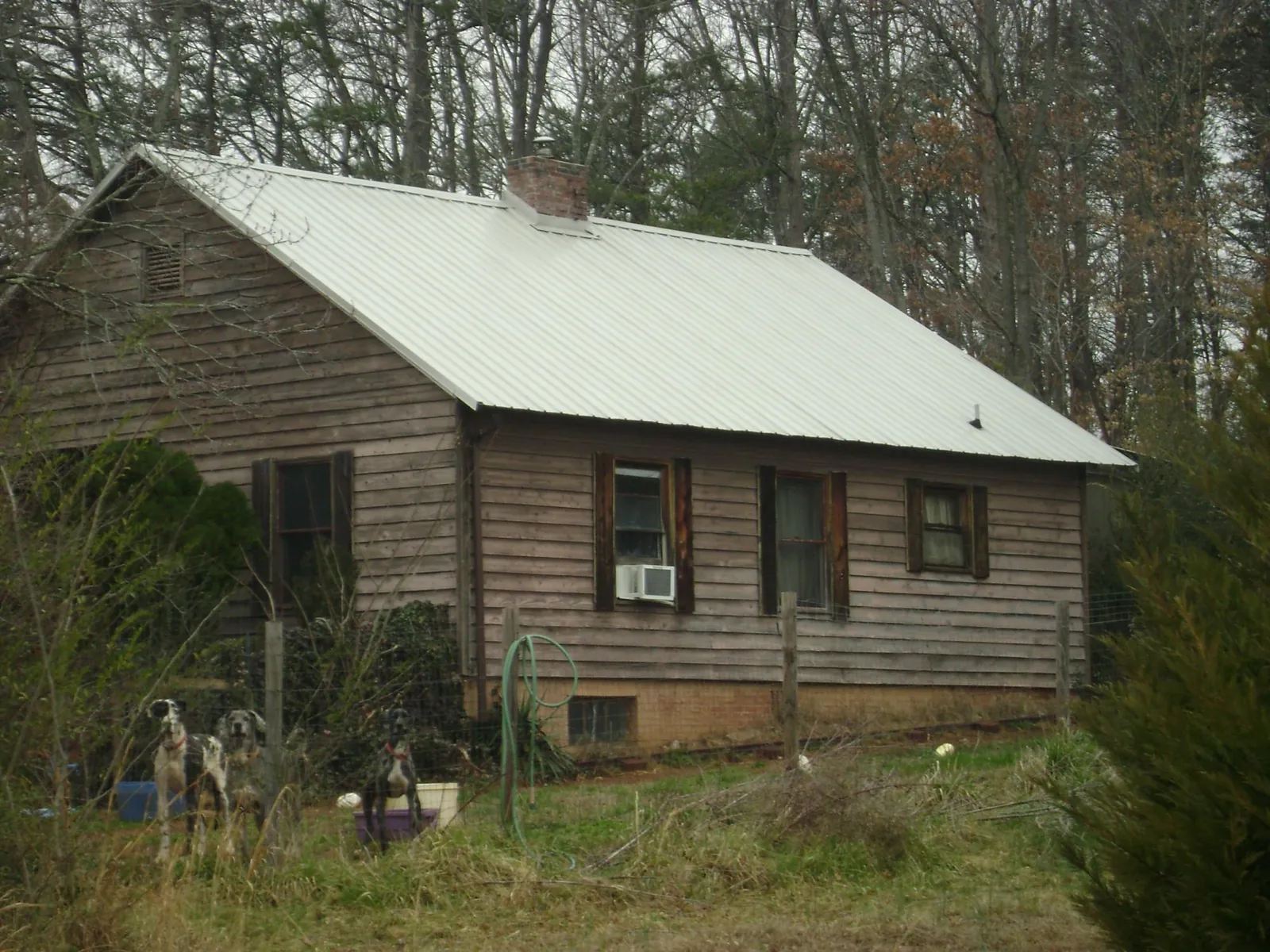 White metal roof on an old wood sided farmhouse, from a Metal Roof Installation job in Dumfries